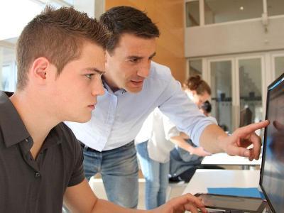Instructor and student using a computer.